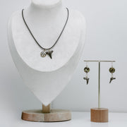 Necklace and earrings on a mannequin and stand against a white background