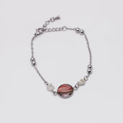 Silver bracelet with a pink lionfish fins on a white background