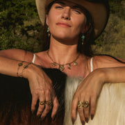 Woman wearing a cowboy hat with a scenic background