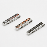 Three silver tie clips with lionfish inlay on a white background
