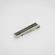 Silver tie clip with lionfish pelvic fin inlay on a white background