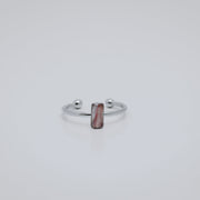 Silver ring with a small vertical bar  on a white background