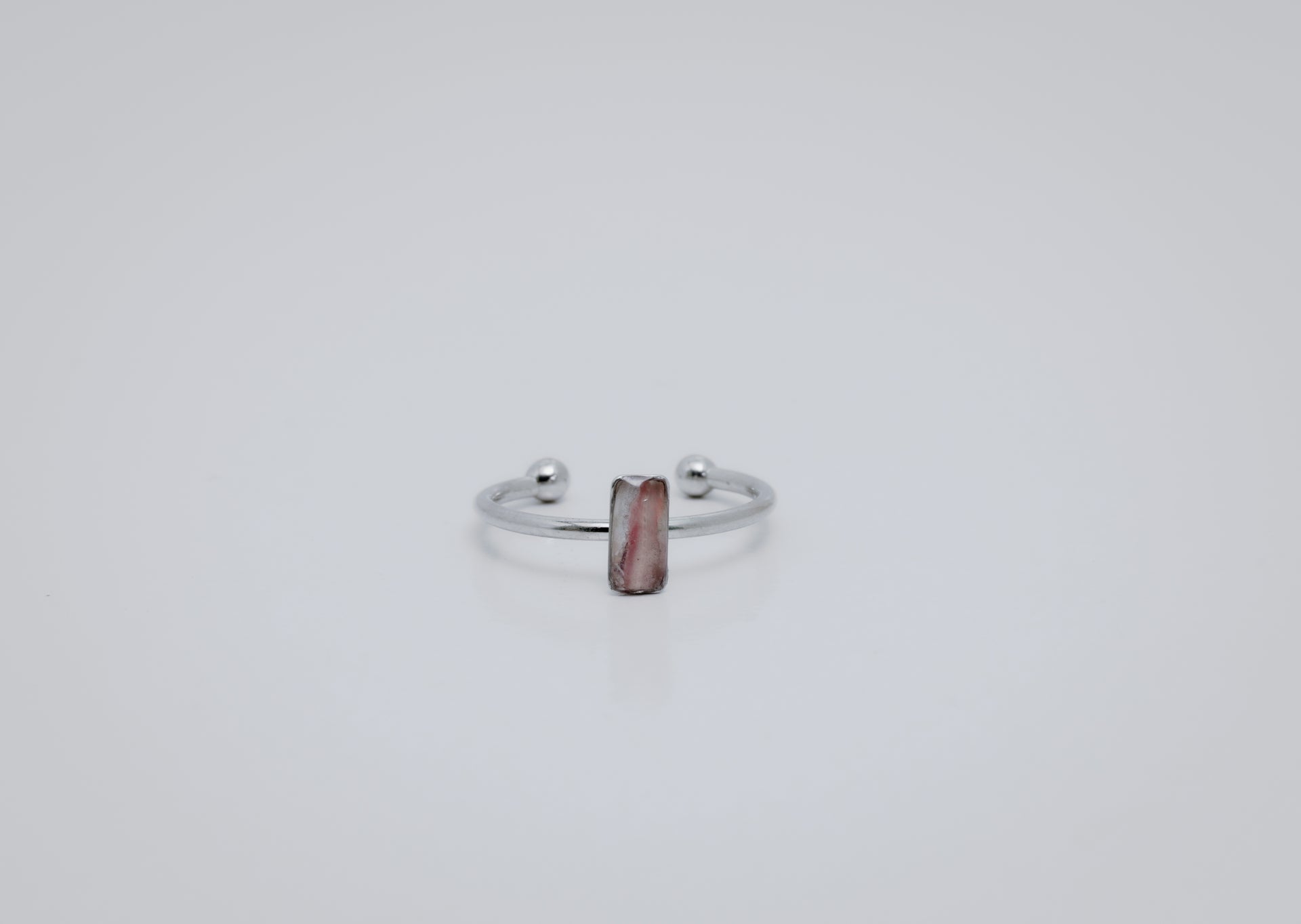 Silver ring with a small vertical bar  on a white background