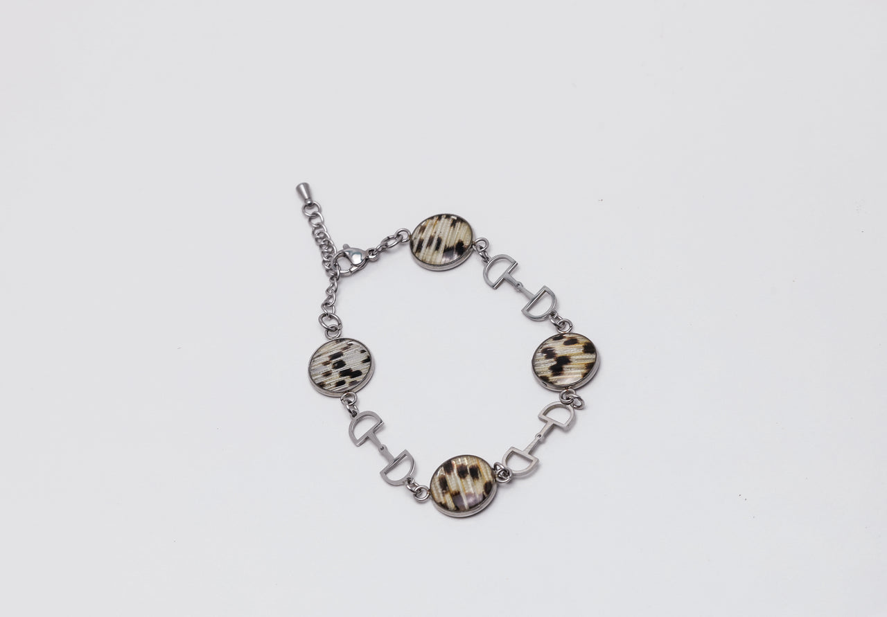 Bracelet with lionfish fins on a light gray background