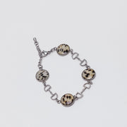 Bracelet with lionfish fins on a light gray background