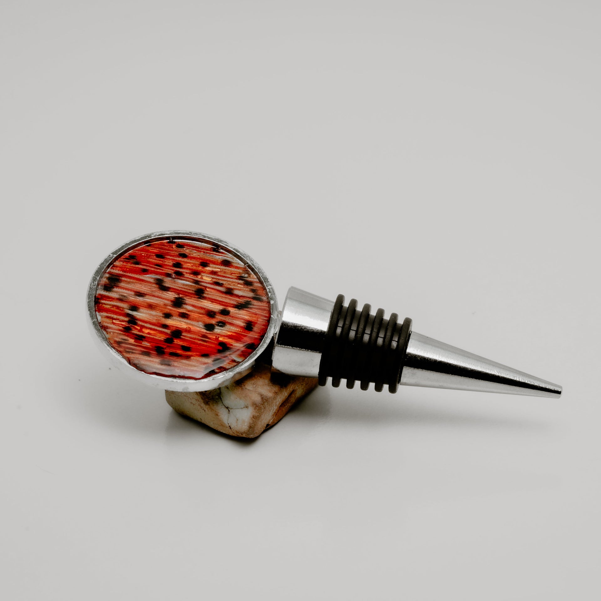 Wine bottle stopper with lionfish tail fin pattern on a white background