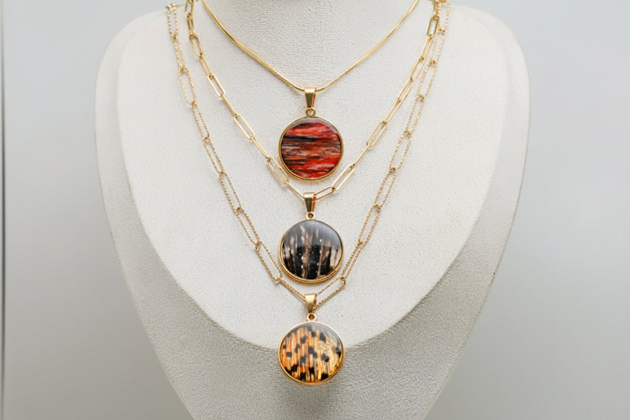 Three X-Large Gold Necklaces on a cream necklace display bust. 