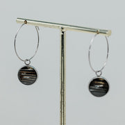 Silver Hoops on a gold stand on a white background.  