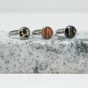 Three Silver Adjustable Rings on black and white marble on a white background.