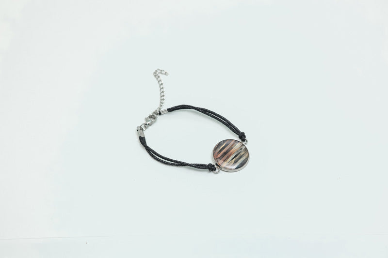 A Black Cord Bracelet on a white background. 