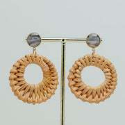 Boho Rattan Hoop Earrings on a gold stand on a white background.