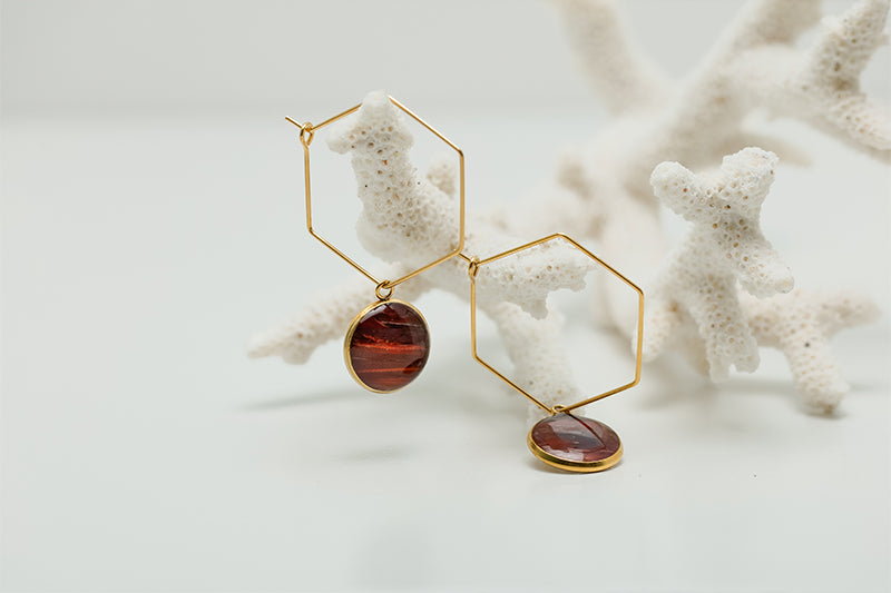 Gold Hexagon Hoops on white coral on a white background.