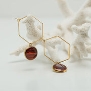Gold Hexagon Hoops on white coral on a white background.