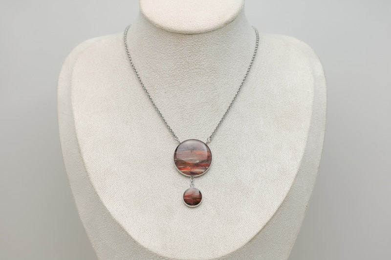 An Adjustable Statement Necklace on a cream necklace display bust. 