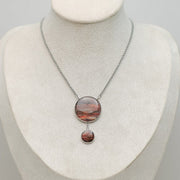 An Adjustable Statement Necklace on a cream necklace display bust. 