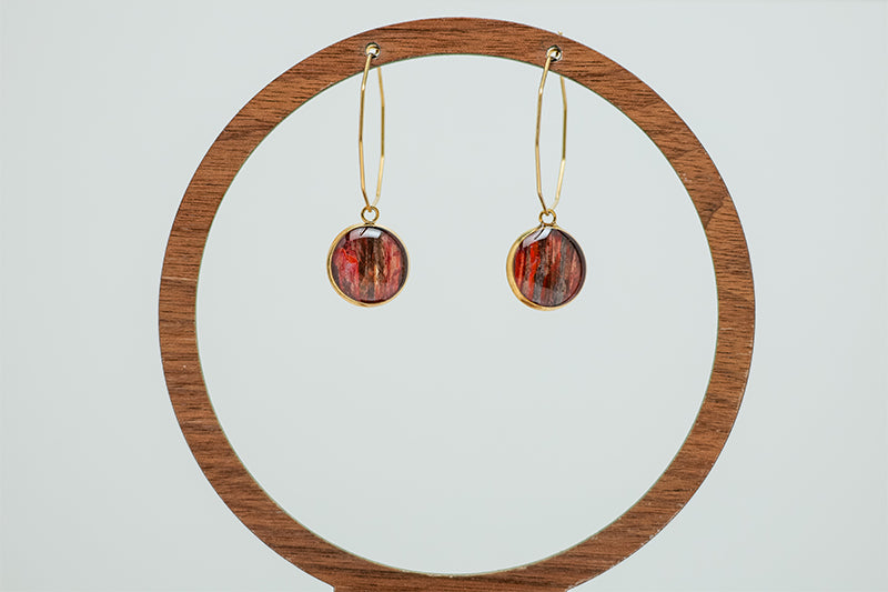 Gold Hexagon Hoops on a circular wooden stand on a white background.  