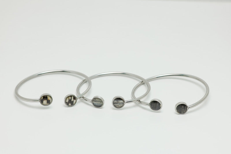 Three Double Silver Pendant Cuffs on a white background.