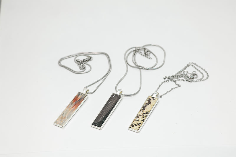 Three Bar Necklaces on a white background.