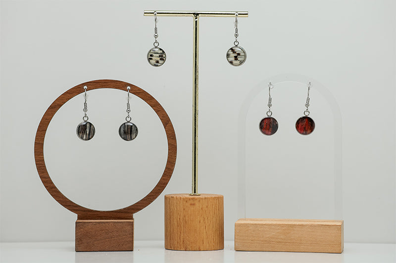 Three pairs of Simple Dangles on stands on a white background.  