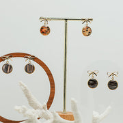 Three pairs of Mini Bow Posts on stands on a white background with a white coral at the bottom of the image.