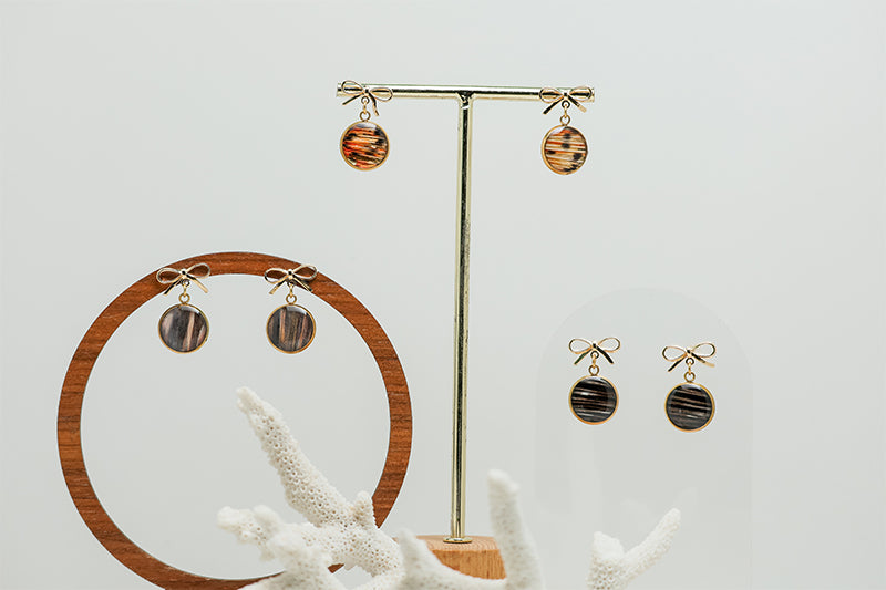 Three pairs of Mini Bow Posts on stands on a white background with a white coral at the bottom of the image.