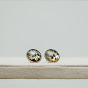 Large Studs on a cream stand on a white background. 