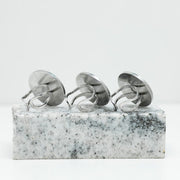 Three Silver Statement Rings on black and white marble on a white background.