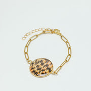 A Gold Paperclip Bracelet on a white background. 