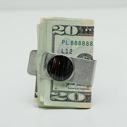 Silver Money Clip holding a $20 bill on a white background. 