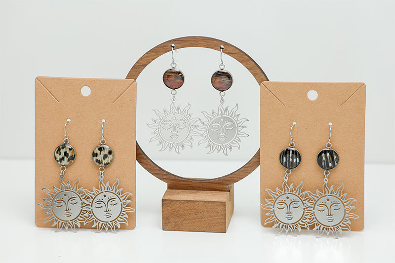 Three pairs of Sunshine on a Cloudy Day Earrings on stands on a white background.  