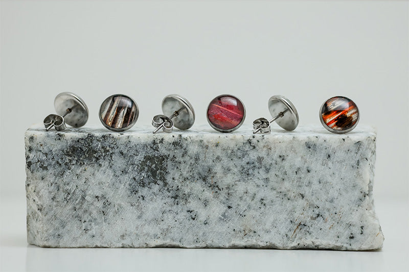 Three pairs of Medium Studs on black and white marble on a white background.