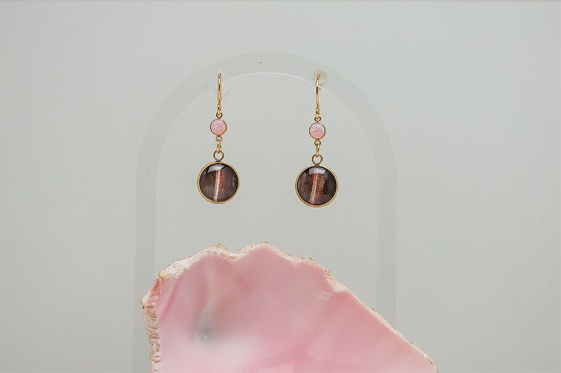 Seashell Pink Opal Earrings on a white background with a pink shell at the bottom of the image. 