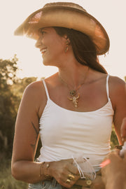 Woman wearing Ranch Royale lionfish necklace with western style