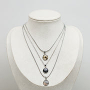 Small silver lionfish necklace showcasing three fin designs, sustainable handmade ocean jewelry